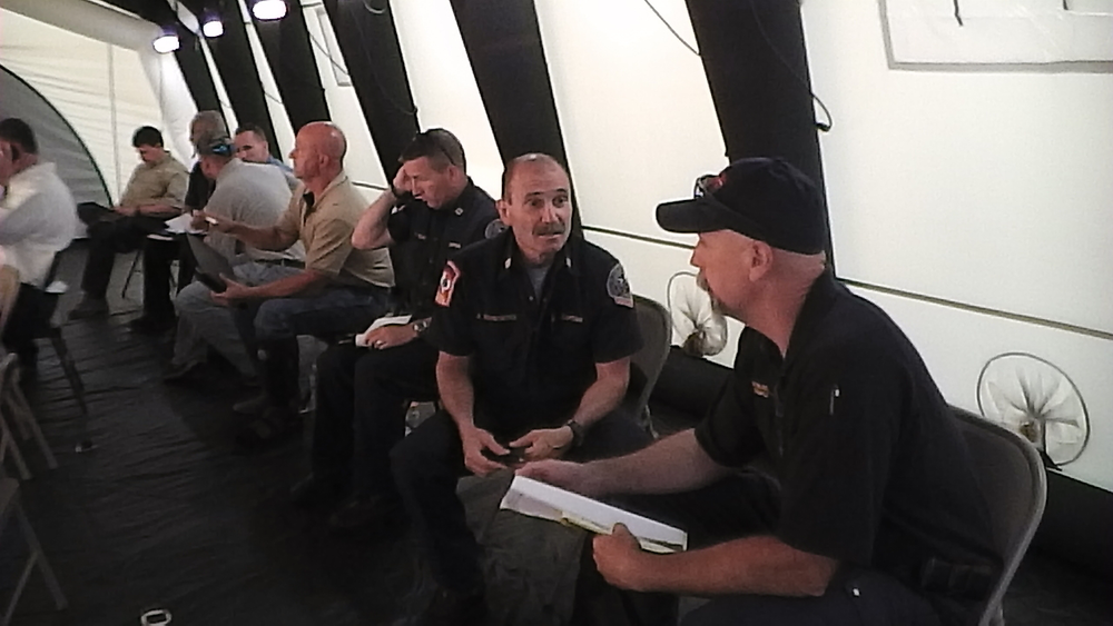 Firefighters with the Texas LODD Task Force discuss plans at a meeting Monday night.