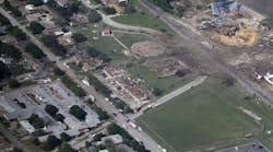 This Thursday, April 18, 2013 aerial photo shows the remains of a nursing home, left, apartment complex, center, and fertilizer plant, right, destroyed by an explosion in West, Texas. Rescuers searched the smoking remnants for survivors of Wednesday night&apos;s thunderous fertilizer plant explosion, gingerly checking smashed houses and apartments for anyone still trapped in debris. (AP Photo/Tony Gutierrez)