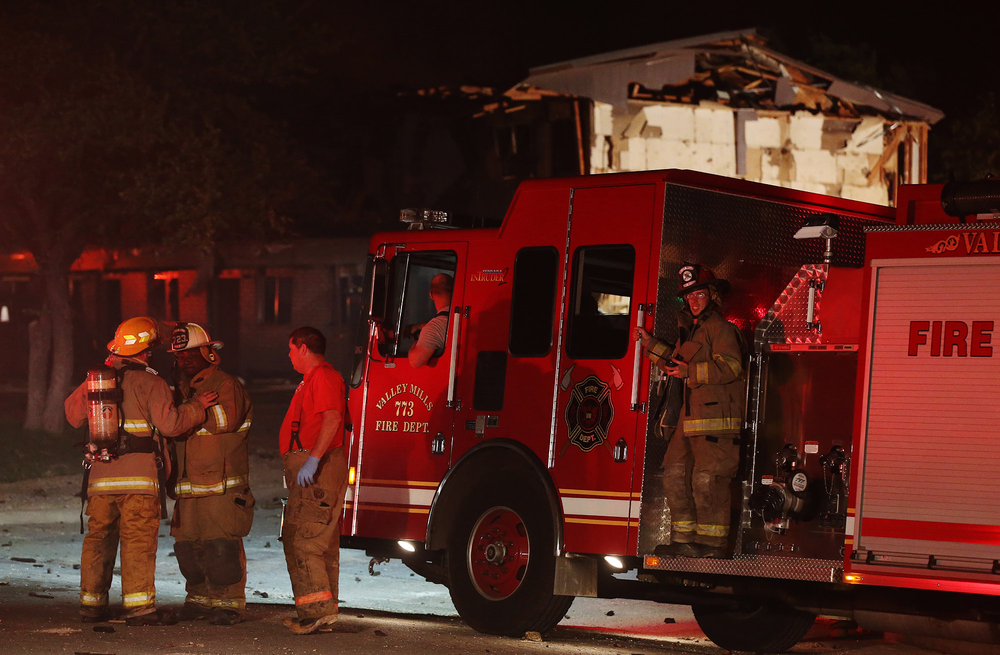 Rescue workers gather near a damaged apartment complex after a nearby fertilizer plant exploded, April 17, 2013, in West, Texas.