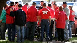 Members of the West Volunteer Fire Department gather after attending a service at St. Mary&apos;s Church of the Assumption on Friday.