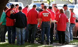 Members of the West Volunteer Fire Department gather after attending a service at St. Mary's Church of the Assumption on Friday. Members of the West Volunteer Fire Department gather after attending a service at St. Mary's Church of the Assumption on Friday.