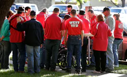 Members of the West Volunteer Fire Department gather after attending a service at St. Mary's Church of the Assumption on Friday.