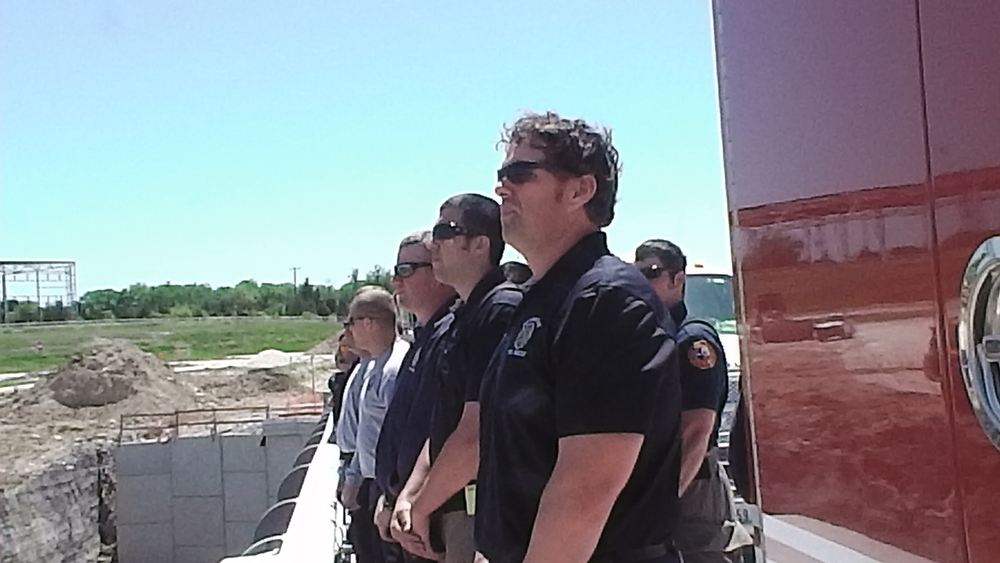 Firefighters from surrounding companies wait to salute their fallen brothers.