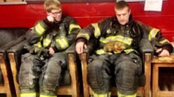 A baby fox rescued from a storm drain rests on the lap of a firefighter with the Joppa-Magnolia Volunteer Fire Company.