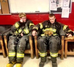 A baby fox rescued from a storm drain rests on the lap of a firefighter with the Joppa-Magnolia Volunteer Fire Company.