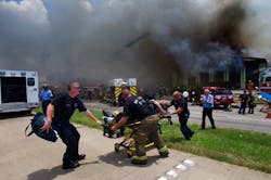 A firefighter is wheeled to an ambulance after fighting a fire at the Southwest Inn, Friday, May 31, 2013, in Houston. A firefighter is wheeled to an ambulance after fighting a fire at the Southwest Inn, Friday, May 31, 2013, in Houston.