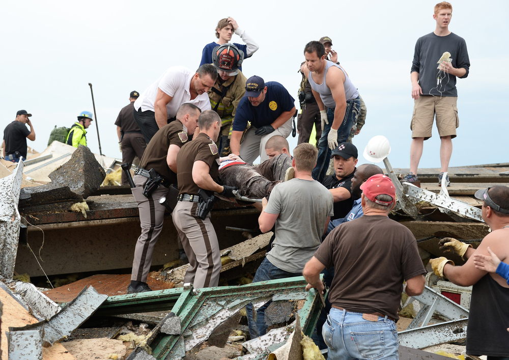 A victim is removed from Oklahoma tornado debris.