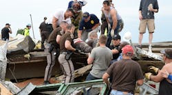 A victim is removed from Oklahoma tornado debris.