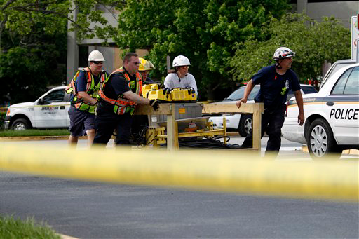 Montgomery County rescue crews move equipment toward a garage collapse.