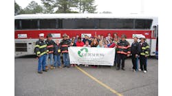 Charles Keeling (second from right), Safety Director, Gershow Recycling, poses with members of the Hagerman Fire Department, the South Country Ambulance Corps and the &ldquo;crash victims&rdquo; in front of a passenger bus provided by Gershow for a mass casualty drill.