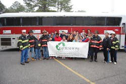 Charles Keeling (second from right), Safety Director, Gershow Recycling, poses with members of the Hagerman Fire Department, the South Country Ambulance Corps and the &ldquo;crash victims&rdquo; in front of a passenger bus provided by Gershow for a mass casualty drill.