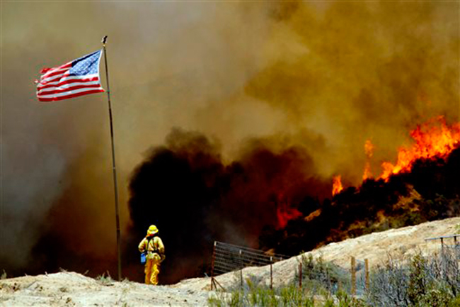 A flare-up prompted Los Angeles County sheriff's deputies to briefly evacuate about 25 homes along a canyon road in the Angeles National Forest Friday morning but residents were later allowed to return.