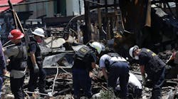 Arson investigators sift through the debris Monday, June 3, 2013, at the scene of a deadly motel fire in Houston. Four Houston firefighters died last week when the roof collapsed as they were inside the burning restaurant and motel. Three firefighters remain hospitalized, one in critical condition. (AP Photo/Pat Sullivan)