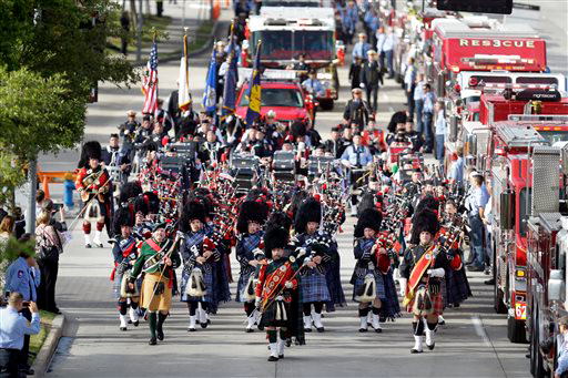 Firefighters march in Houston on Wednesday to honor their fallen sister and brothers.