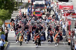 Firefighters march in Houston on Wednesday to honor their fallen sister and brothers.