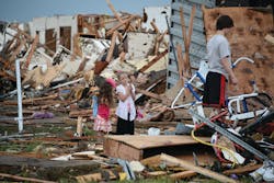Children wait outside of what was once their home while their father searches in debris. Children wait outside of what was once their home while their father searches in debris.