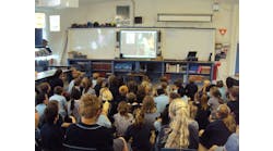 A packed classroom watches on as Dayna Hilton and her fire safety dogs share fire prevention messages via Skype.