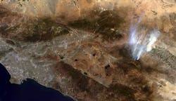 This image provided by NASA shows the agency&apos;s Terra spacecraft photo showing smoke from a wildfire near Idyllwild, Calif., right, and the Los Angeles area, left. The blaze in the San Jacinto Mountains has expanded to roughly 39 square miles and was 15 percent contained Friday July 19, 2013.