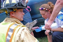 Jeff Doskos and Middlesex Hospital Paramedic Nikki Matthews help a greyhound after a two-car collision on Route 81 in Higganum on July 11. In addition to being a paramedic, Matthews studied Animal Science at the University of Connecticut.