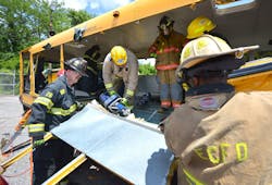 Students in Ron Moore's school bus extrication class used a variety of tools to perform basic and advanced extrication skills on a school bus at Firehouse Expo Tuesday. Students in Ron Moore's school bus extrication class used a variety of tools to perform basic and advanced extrication skills on a school bus at Firehouse Expo Tuesday.