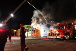 Firefighters mop up after extinguishing a fire at the historic Oyster House restaurant on the downtown Olympia, Wash., waterfront early morning Friday, July 19.