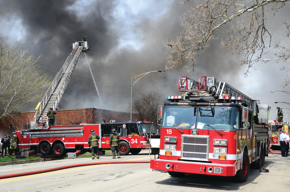 Chicago, IL: April 29, 2013- - A defensive attack was made on a fully involved one-story commercial building with a bowstring truss roof. Tower Ladders 34 and 37 and Squad 5A were set up. It took about two hours to control the 3-11 alarm fire.