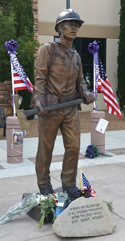 A life-size statue of a Hotshots firefighter stands in front of the 6,000-seat arena in Prescott Valley, AZ, where the memorial service was held.