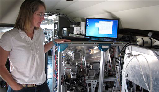 Jennifer Comstock, a researcher at Pacific Northwest National Laboratory, shows equipment used to obtain particles.