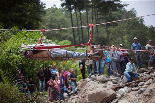 A victim is hoisted from a bus crash.