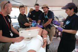 DMAT members treat the symptoms shown by a patient simulator while training at FEMA’s Center for Domestic Preparedness. DMAT members treat the symptoms shown by a patient simulator while training at FEMA’s Center for Domestic Preparedness.