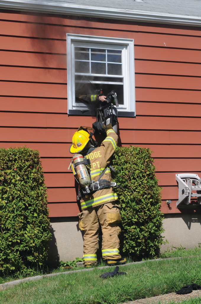 Woodbridge Firefighter Ryan Horvath hands his self-contained breathing apparatus (SCBA) out a bedroom rear window to a second firefighter before diving head-first out the window and falling to the ground. He was first to escape the fire after two firefighters become disoriented and issued a 'Mayday.'