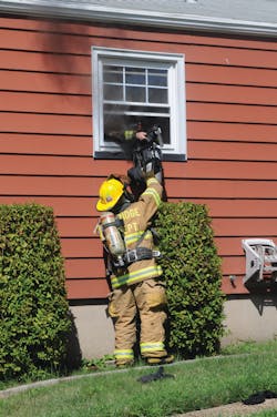 Woodbridge Firefighter Ryan Horvath hands his self-contained breathing apparatus (SCBA) out a bedroom rear window to a second firefighter before diving head-first out the window and falling to the ground. He was first to escape the fire after two firefighters become disoriented and issued a &apos;Mayday.&apos;
