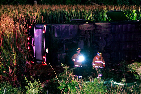 Officials work the scene of an overturned Greyhound bus on interstate I-75 in Liberty Township, Ohio on Saturday, Sept. 14, 2013. Authorities say that at least 34 people have been hurt, with injuries ranging from minor to severe.