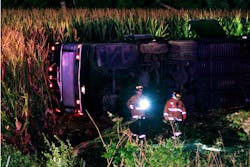 Officials work the scene of an overturned Greyhound bus on interstate I-75 in Liberty Township, Ohio on Saturday, Sept. 14, 2013. Authorities say that at least 34 people have been hurt, with injuries ranging from minor to severe.