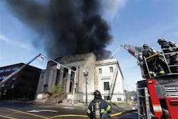 Firefighters spray water on a burning building Monday, Sept. 30, 2013, in Quincy, Mass. The historic building was built in 1926 as a Masonic Temple.