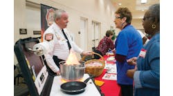 Las Vegas Fire &amp; Rescue Public Education &amp; Information Officer Timothy R. Szymanski talks with Marlene Moran during a Senior Safety Fair in October. Senior citizens were taught how to prevent fires and how to escape safely should a fire occur.