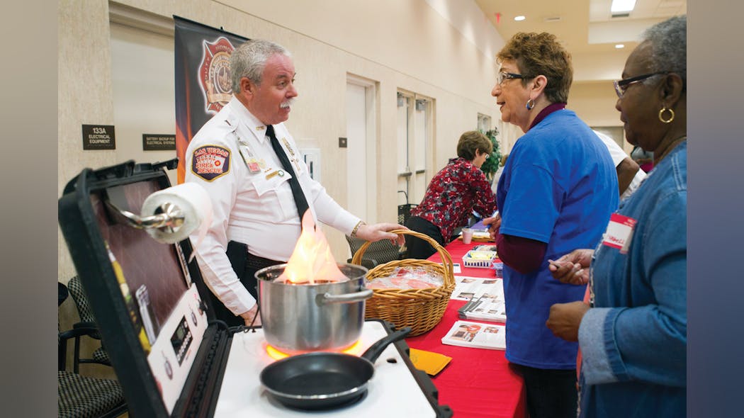 Las Vegas Fire &amp; Rescue Public Education &amp; Information Officer Timothy R. Szymanski talks with Marlene Moran during a Senior Safety Fair in October. Senior citizens were taught how to prevent fires and how to escape safely should a fire occur.