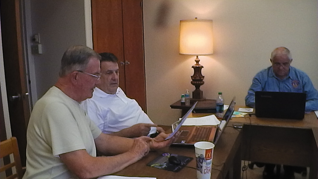 The production crew, from left, Crawford Weistling, Ken Farmer and Larry Curl, director, go over details at a meeting Thursday.