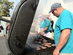 Vigilant Hose Company members, Tim Clark, foreground, and Bob Boyd grill burgers they are serving to hundreds of firefighters. Vigilant Hose Company members, Tim Clark, foreground, and Bob Boyd grill burgers they are serving to hundreds of firefighters.