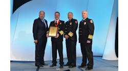 Golden Valley, AZ, Fire Chief Thomas O&apos;Donohue, second from left, is pictured with Motorola Solutions Corporate Vice President Kelly Kerwan; Chief Hank Clemmensen of the Palatine Rural Fire Protection District in Inverness, IL, the outgoing president of the International Association of Fire Chiefs; and Golden Valley Assistant Fire Chief Ted Martin, after receiving the 2013 International Association of Fire Chiefs/Motorola Solutions Benjamin Franklin Fire Service Award for Valor at Fire Rescue International 2013. O&apos;Donohue is the first chief to receive the award.