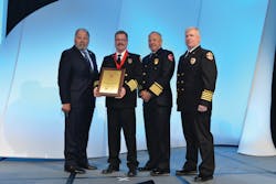Golden Valley, AZ, Fire Chief Thomas O'Donohue, second from left, is pictured with Motorola Solutions Corporate Vice President Kelly Kerwan; Chief Hank Clemmensen of the Palatine Rural Fire Protection District in Inverness, IL, the outgoing president of the International Association of Fire Chiefs; and Golden Valley Assistant Fire Chief Ted Martin, after receiving the 2013 International Association of Fire Chiefs/Motorola Solutions Benjamin Franklin Fire Service Award for Valor at Fire Rescue International 2013. O'Donohue is the first chief to receive the award. Golden Valley, AZ, Fire Chief Thomas O'Donohue, second from left, is pictured with Motorola Solutions Corporate Vice President Kelly Kerwan; Chief Hank Clemmensen of the Palatine Rural Fire Protection District in Inverness, IL, the outgoing president of the International Association of Fire Chiefs; and Golden Valley Assistant Fire Chief Ted Martin, after receiving the 2013 International Association of Fire Chiefs/Motorola Solutions Benjamin Franklin Fire Service Award for Valor at Fire Rescue International 2013. O'Donohue is the first chief to receive the award.