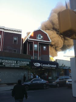 Heavy smoke rises skyward as the first apparatus approach the scene. The battalion chief ordered a second alarm as he arrived.