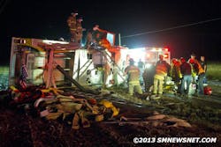 Firefighters work at the scene of the rollover. Firefighters work at the scene of the rollover.