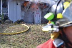 Firefighter Candace Wetter, right, and the nozzleman after they bailed out of the burn building. Firefighter Candace Wetter, right, and the nozzleman after they bailed out of the burn building.