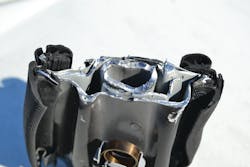 In this cross-section of the B-pillar, it is possible to see the outer metal that makes up the shape of the pillar. An additional curved layer of hot-stamped Boron steel can be seen inside the pillar itself (light grey-colored metal). The strong Boron steel pipe inside the hollow of the B-pillar is also visible. In this cross-section of the B-pillar, it is possible to see the outer metal that makes up the shape of the pillar. An additional curved layer of hot-stamped Boron steel can be seen inside the pillar itself (light grey-colored metal). The strong Boron steel pipe inside the hollow of the B-pillar is also visible.