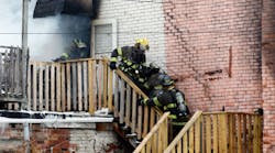 Toledo firefighters rush a fellow firefighter down the stairs of a six unit apartment building at 528 Magnolia in Toledo.