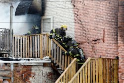 Toledo firefighters rush a fellow firefighter down the stairs of a six unit apartment building at 528 Magnolia in Toledo.
