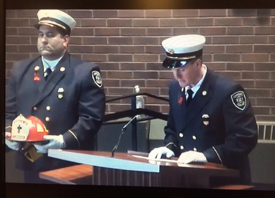 Penfield Fire Chief Christopher Ebmyer honors Tyler at his funeral.