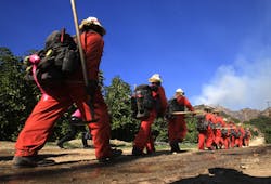 An inmate hand crew heads up a fire access road to fight the Colby fire in Glendora, Calif., on Thursday, Jan. 16, 2014. An inmate hand crew heads up a fire access road to fight the Colby fire in Glendora, Calif., on Thursday, Jan. 16, 2014.