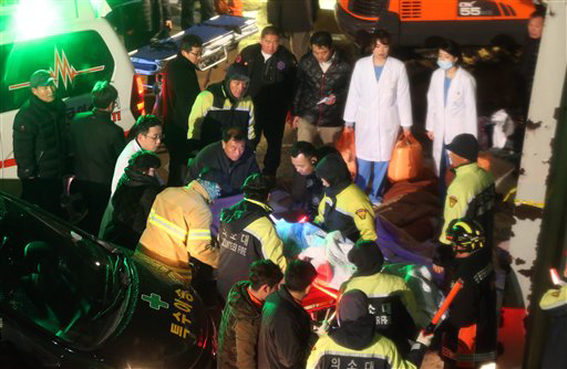 Korean responders aid victims of collapse.
